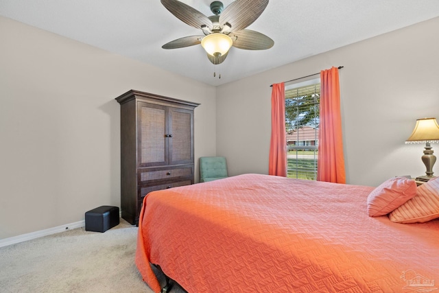 bedroom with light carpet, a ceiling fan, and baseboards