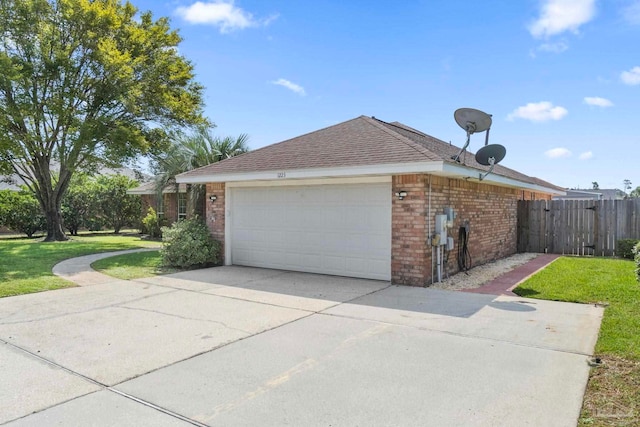 view of property exterior featuring brick siding, concrete driveway, a lawn, fence, and a garage