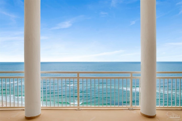 balcony with a water view and a beach view