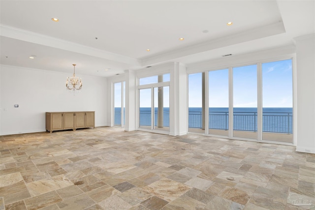 13555 Sandy Key Dr Ph, Ph, Perdido Key, FL 32507 - empty room featuring a notable chandelier, a water view, a raised ceiling, and stone finish flooring