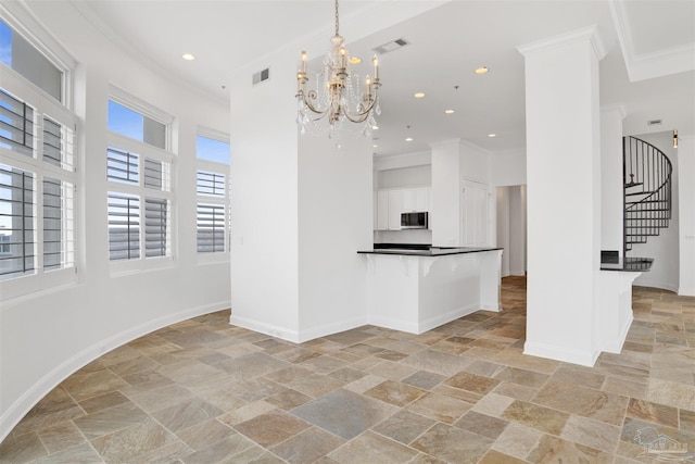 13555 Sandy Key Dr Ph, Ph, Perdido Key, FL 32507 - interior space featuring visible vents, stone tile flooring, crown molding, and stainless steel microwave