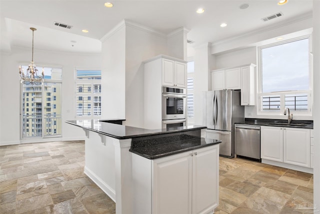 13555 Sandy Key Dr Ph, Ph, Perdido Key, FL 32507 - kitchen featuring a sink, stainless steel appliances, stone tile floors, visible vents, and ornamental molding