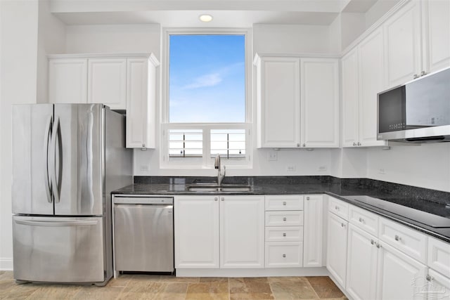 13555 Sandy Key Dr Ph, Ph, Perdido Key, FL 32507 - kitchen featuring white cabinetry, stainless steel appliances, dark stone counters, and a sink