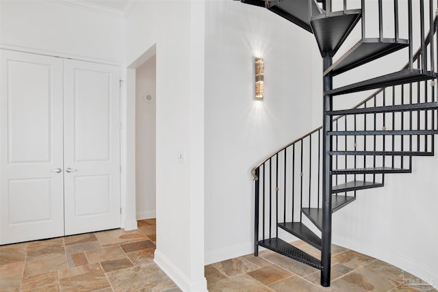 stairway featuring crown molding