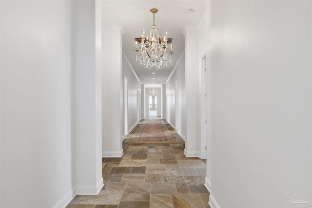 13555 Sandy Key Dr Ph, Ph, Perdido Key, FL 32507 - hall with ornamental molding, stone tile flooring, a notable chandelier, and baseboards