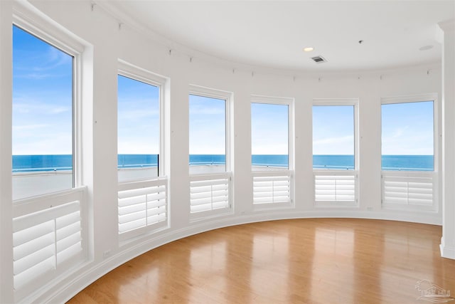 interior space featuring a water view and a beach view