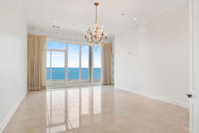 tiled empty room with a water view, ornamental molding, and an inviting chandelier