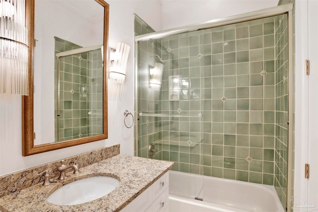 bathroom featuring enclosed tub / shower combo and vanity