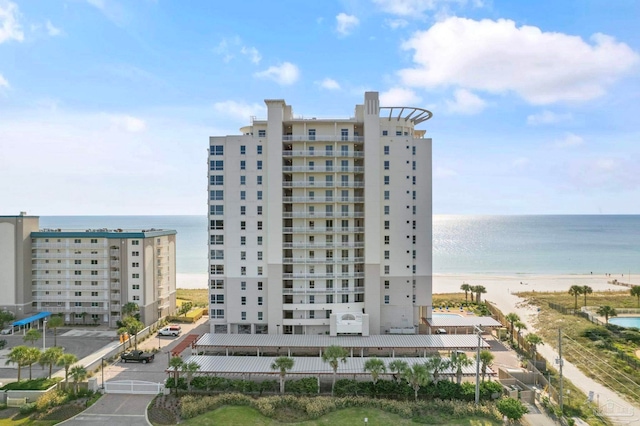 view of property featuring a view of the beach and a water view