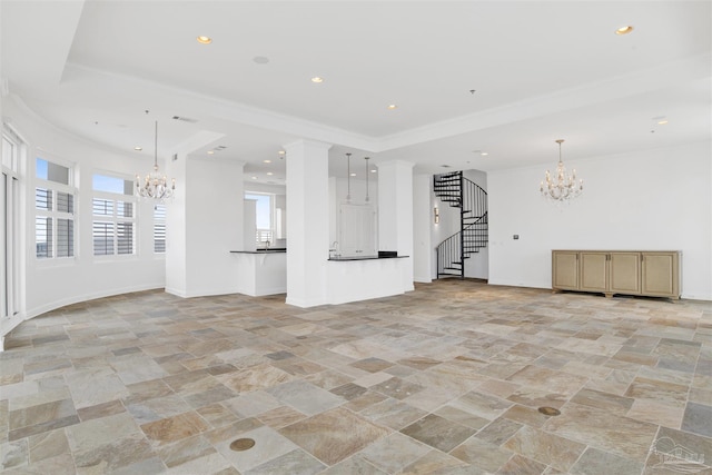 13555 Sandy Key Dr Ph, Ph, Perdido Key, FL 32507 - unfurnished living room featuring a notable chandelier, stone tile flooring, and plenty of natural light