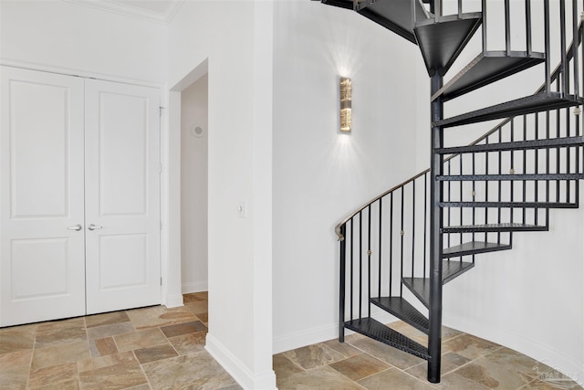 13555 Sandy Key Dr Ph, Ph, Perdido Key, FL 32507 - stairway with stone tile floors, baseboards, and crown molding