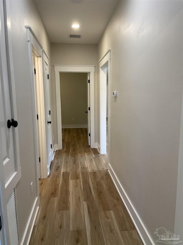 hall with light hardwood / wood-style floors