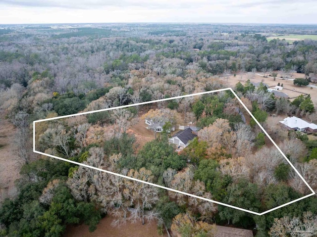 birds eye view of property with a view of trees