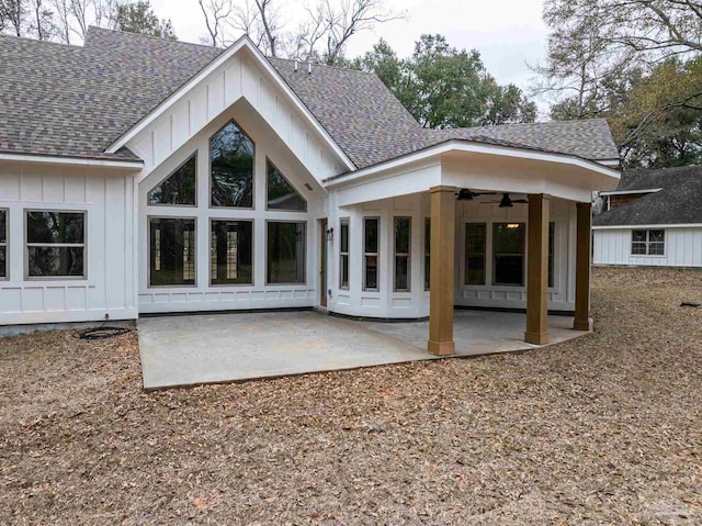 back of house featuring board and batten siding, a shingled roof, a ceiling fan, and a patio