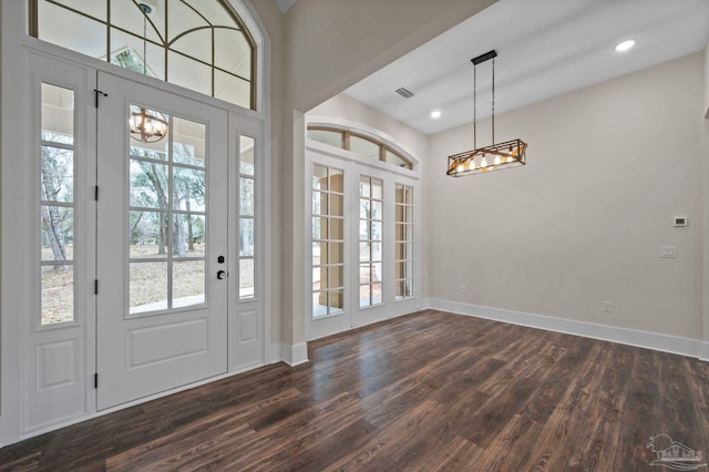 entryway featuring dark wood-style floors, visible vents, plenty of natural light, and baseboards