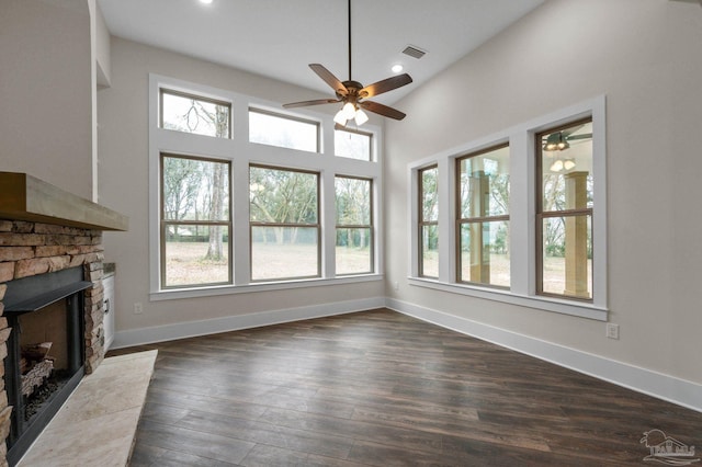 unfurnished living room featuring visible vents, baseboards, dark wood finished floors, recessed lighting, and a fireplace