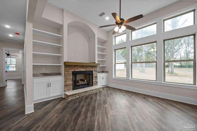 unfurnished living room featuring dark wood finished floors, visible vents, baseboards, and built in features