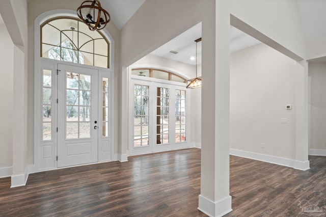 foyer with an inviting chandelier, dark wood-style floors, and a wealth of natural light