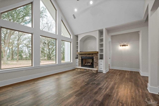 unfurnished living room with built in features, a fireplace, baseboards, and dark wood-style flooring