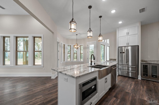 kitchen featuring a sink, stainless steel appliances, white cabinets, and dark wood-style flooring