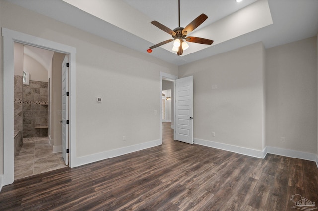 unfurnished bedroom with baseboards, dark wood-type flooring, and ceiling fan