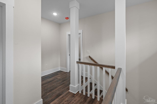 stairway featuring recessed lighting, decorative columns, baseboards, and wood finished floors