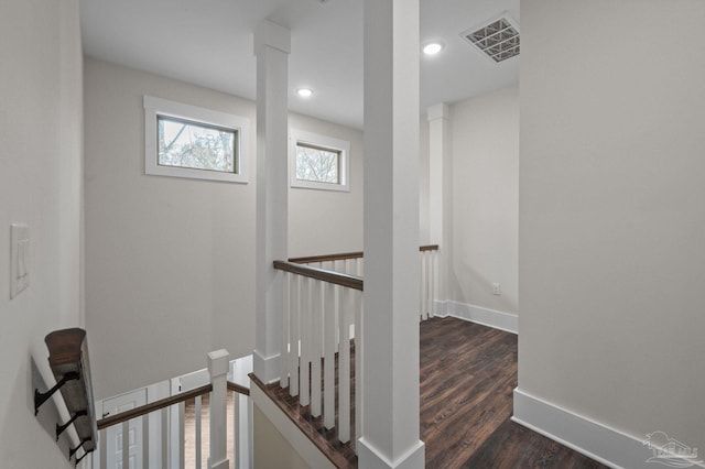 corridor featuring visible vents, an upstairs landing, recessed lighting, baseboards, and dark wood-style flooring