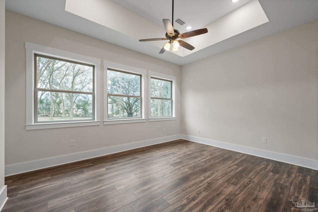 empty room featuring recessed lighting, visible vents, baseboards, and dark wood-type flooring