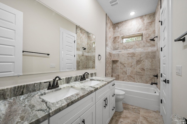 full bathroom featuring a sink, toilet, double vanity, and shower / tub combination