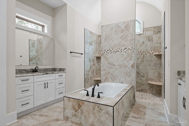 bathroom with walk in shower, a bath, and vanity