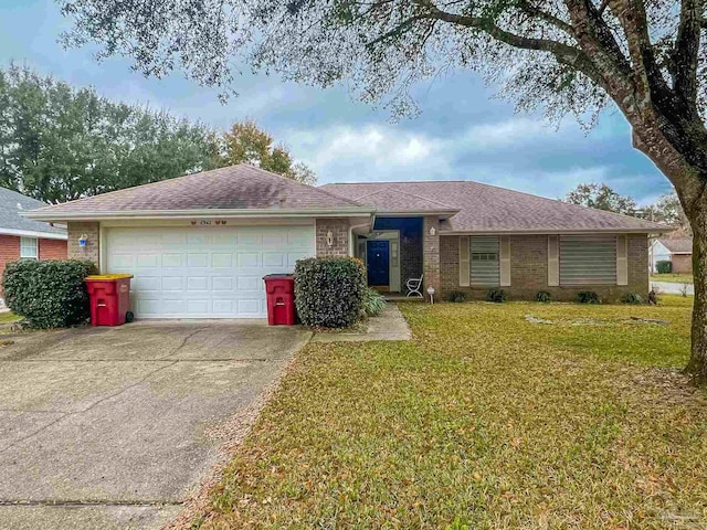 single story home featuring brick siding, an attached garage, concrete driveway, and a front yard