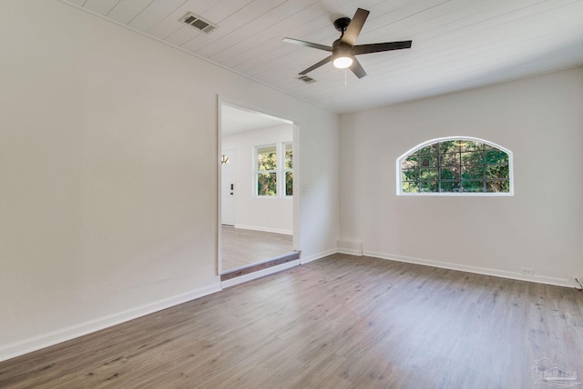 unfurnished room featuring hardwood / wood-style floors, ceiling fan, a healthy amount of sunlight, and wood ceiling