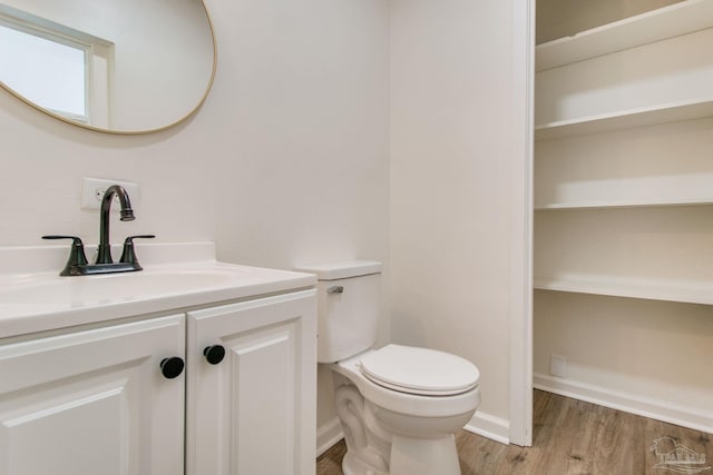 bathroom with vanity, hardwood / wood-style flooring, and toilet