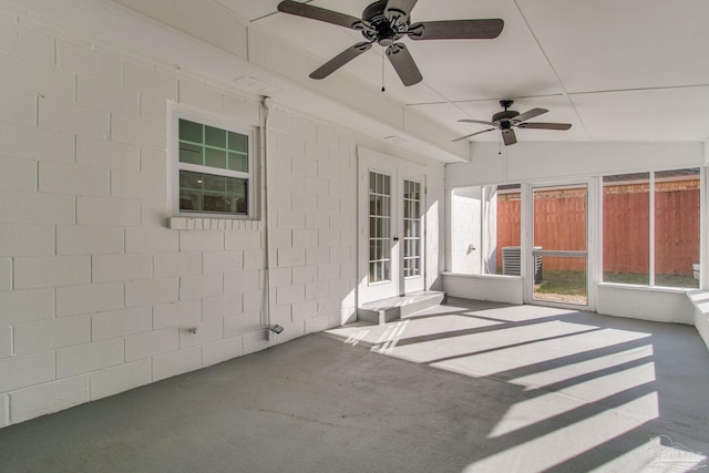 unfurnished sunroom featuring ceiling fan and vaulted ceiling