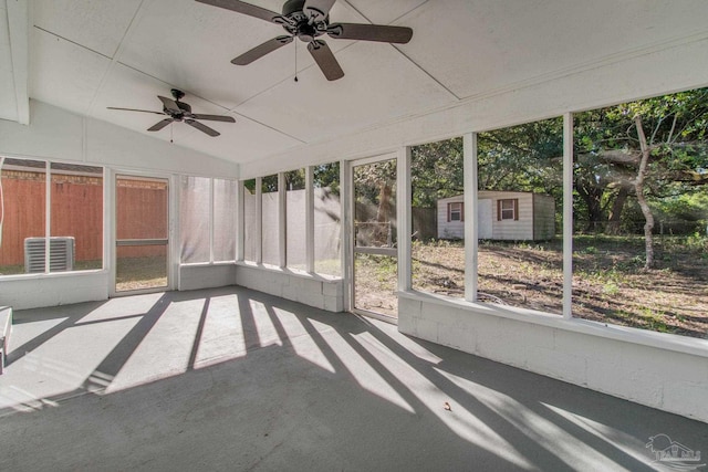 unfurnished sunroom with ceiling fan and vaulted ceiling