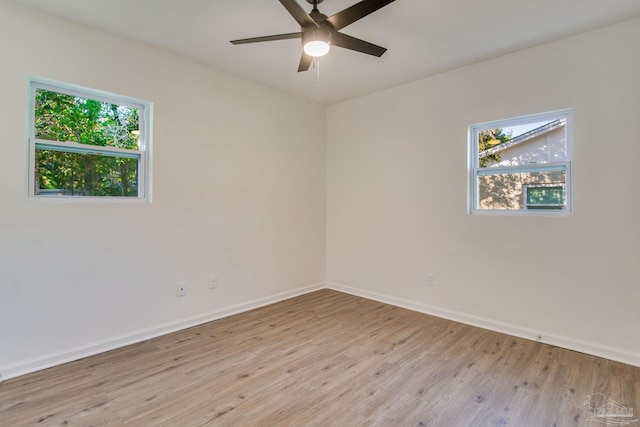 unfurnished room featuring ceiling fan, plenty of natural light, and light wood-type flooring