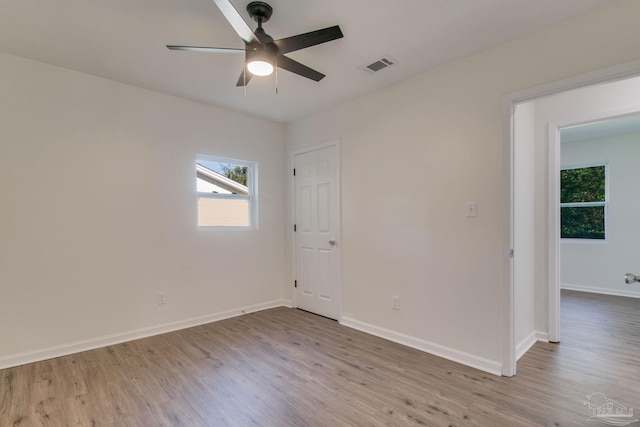 empty room featuring light wood-type flooring and ceiling fan