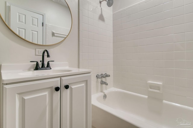 bathroom featuring vanity and tiled shower / bath