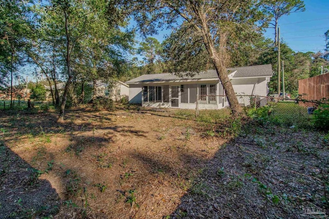 rear view of house featuring a sunroom