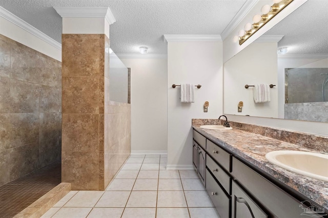 bathroom with vanity, crown molding, tiled shower, and tile patterned floors