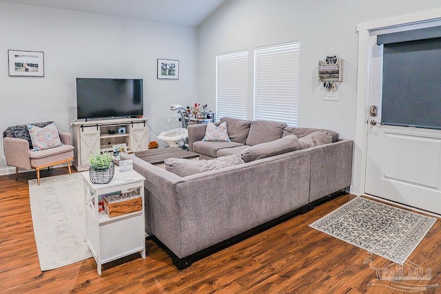 living room with dark wood-type flooring and vaulted ceiling