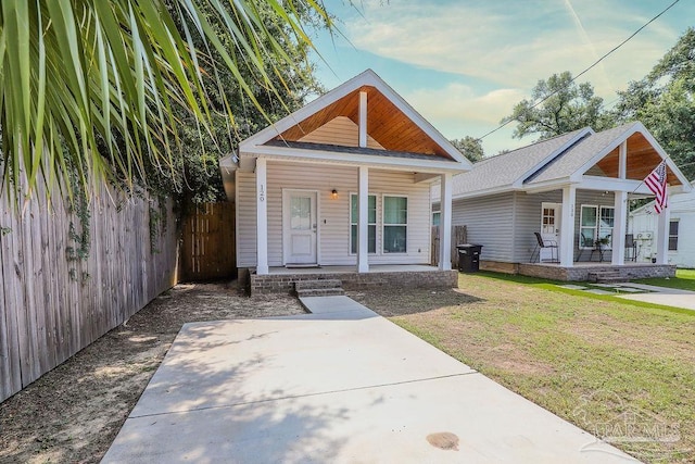 bungalow-style house featuring a porch and a front lawn