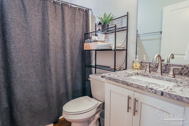 bathroom with toilet, wood-type flooring, and vanity