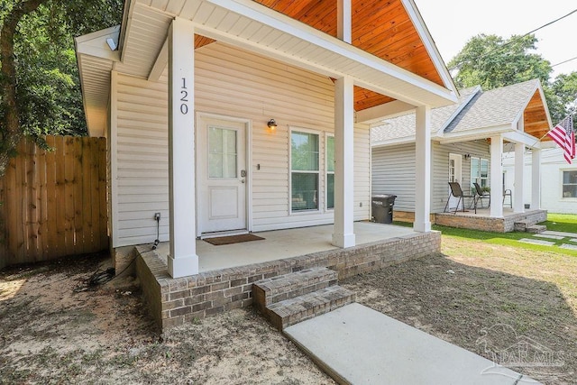 view of exterior entry with a patio