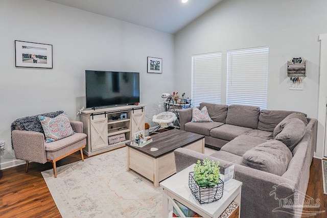 living room featuring dark hardwood / wood-style flooring and lofted ceiling