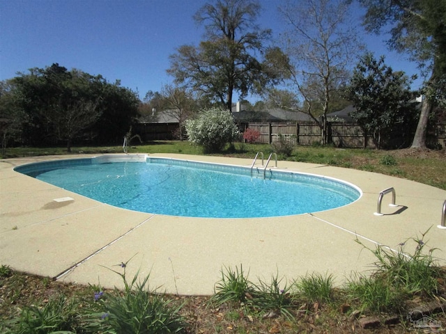 view of swimming pool featuring a fenced in pool, a patio, and fence