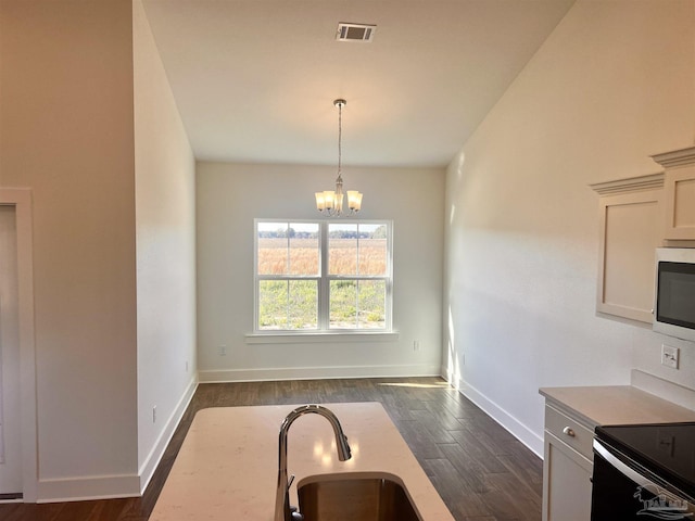 4420 Russell Elliott Rd, Jay, FL 32565 - kitchen with stainless steel microwave, a sink, and dark wood-style flooring