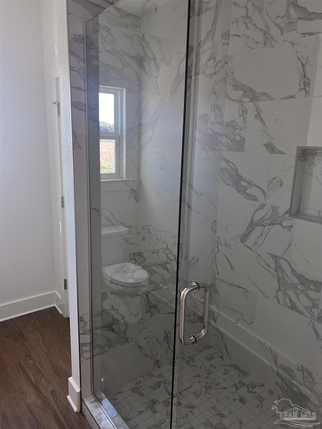 4420 Russell Elliott Rd, Jay, FL 32565 - bathroom featuring a marble finish shower, wood finished floors, and baseboards
