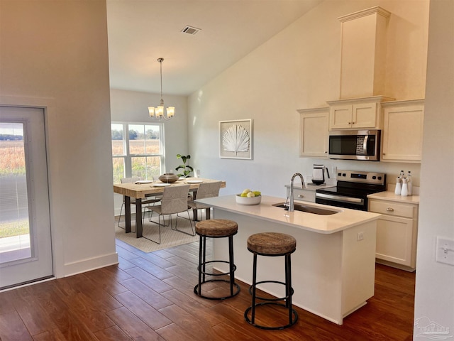 4420 Russell Elliott Rd, Jay, FL 32565 - kitchen with appliances with stainless steel finishes, a sink, dark wood-type flooring, a breakfast bar area, and a chandelier