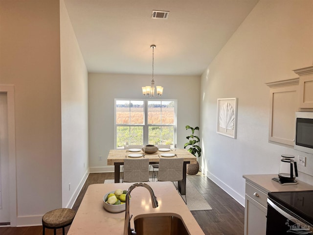 4420 Russell Elliott Rd, Jay, FL 32565 - dining room with a chandelier, baseboards, and dark wood-style flooring